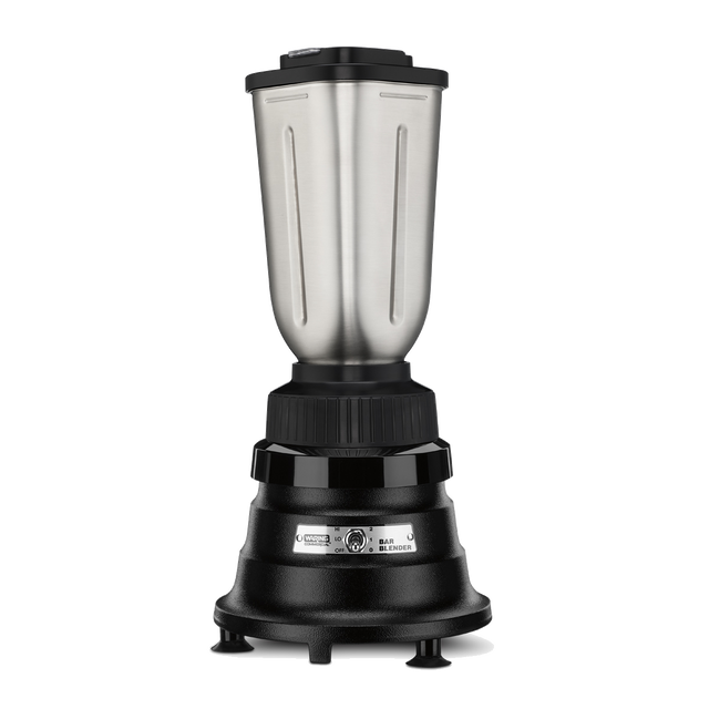 A bar blender with a sturdy black base, central power dial, and four small legs. The tall stainless steel container has a 32 oz. capacity and a black lid, with blend and crush settings labeled on the base. Background is plain white.