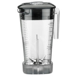 A clear 64 oz blender container from the Xtreme MX series blenders features measurement markings in ounces and milliliters, a black lid, and a sturdy textured base. The Raptor Blender Container has metal blades at the bottom and a convenient right-side handle.