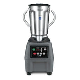 A heavy-duty Food Blender with a large stainless steel container, two side handles, and a black base featuring a digital control panel, display screen, and indicator lights. The Waring brand name is visible on the jug’s lid.