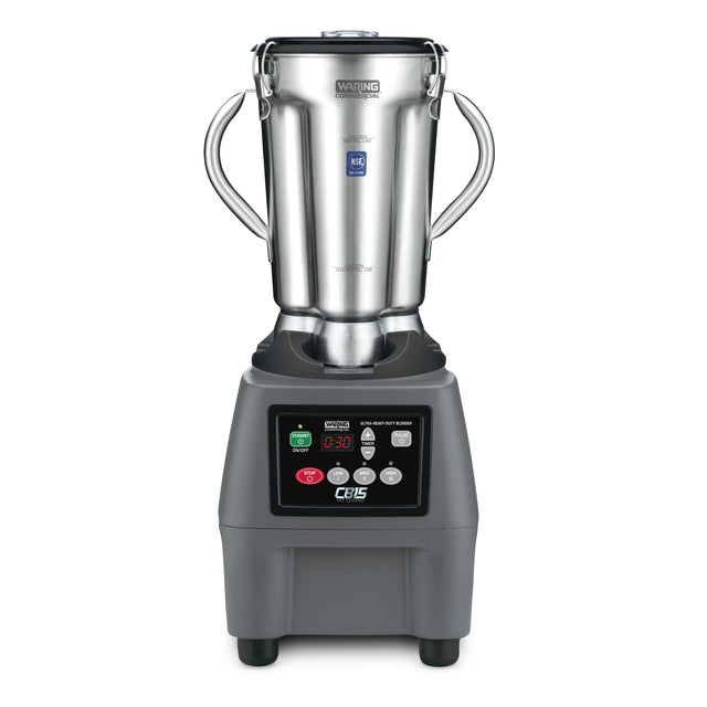 A heavy-duty Food Blender with a large stainless steel container, two side handles, and a black base featuring a digital control panel, display screen, and indicator lights. The Waring brand name is visible on the jug’s lid.