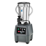 A commercial blender with a sturdy gray base features a control panel with digital display, buttons, and indicator lights. Its large stainless steel container has handles on both sides, a secure lid, pouring spout, and displays the Waring brand.