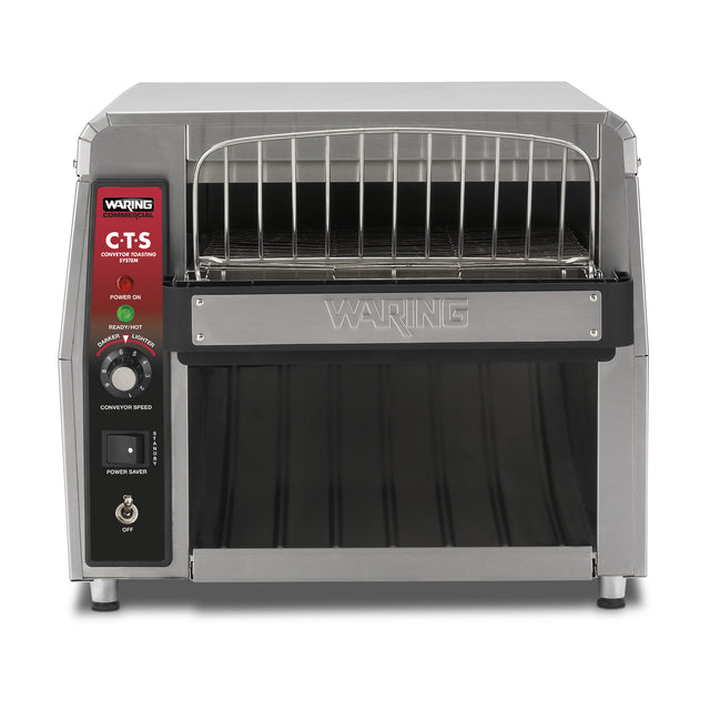 A stainless steel Waring CTS1000AL conveyor toaster with a front loading rack, digital control panel on the left, adjustable conveyor speed knob, power switch, and bottom tray—ideal for international use. Branding and model number are visible.