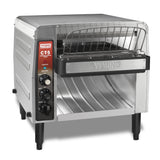 A high volume commercial conveyor toaster, this stainless steel toaster features a front control panel with three black knobs, indicator lights, and a wire rack above the slot. The Waring brand is visible on its front.