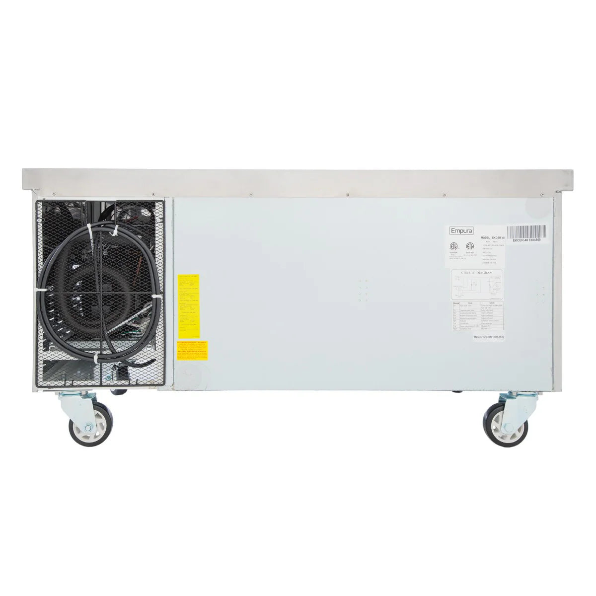 A commercial Empura refrigeration unit viewed from the rear, featuring a stainless steel exterior with ventilation grilles, a visible coiled wire, two large caster wheels, a yellow warning label, and a white manufacturer’s label on the right side.