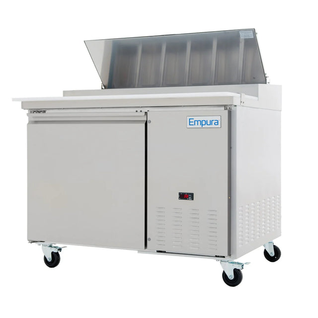 A stainless steel Empura Refrigeration sandwich prep table features a raised, clear-top lid revealing ingredient compartments, a flat cutting surface, refrigerated storage with sliding doors, digital control panel, and four caster wheels for mobility.