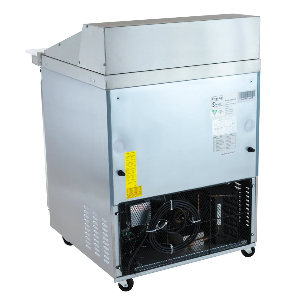 A commercial Empura refrigeration unit on wheels, shown from the back. The lower section reveals an open fan and compressor, with inspection stickers attached. The top section features a sloped metal cover typical of a mega top prep table.