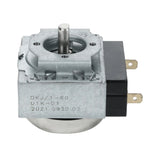 A close-up of a metal and black plastic Magic Chef timer with a rotating shaft, labeled “DKJ/1-60 U1K-01 2021 0930 02.” Two brass prongs protrude from the right side for electrical connections.