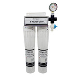 A dual-cartridge Water Filtration System labeled “Empura E-FILTER-2000,” featuring two vertical white filter housings, a top mounting bracket, a pressure gauge, and a blue-handled shut-off valve—ideal for commercial ice machines or as a scale inhibitor.