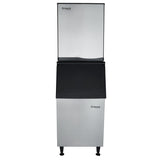 A commercial ice machine with a stainless steel body and black dispenser section. This full cube ice maker, branded “Empura,” is visible on the top door and lower front, and stands on four adjustable legs.