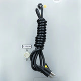 A black power cord neatly coiled is attached to a light gray commercial ice maker. Below the cord, there’s a round white inlet labeled “Ice water inlet.” A small warning triangle and inspection sticker are also visible on the smooth metal surface.