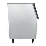 A tall, rectangular metal appliance viewed from the side, featuring a flat, plain silver surface and black legs—ideal as an ice storage bin for Empura ice machines—with a slightly angled top edge and small black handle near the top right corner.