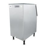 A stainless steel commercial ice storage bin with black legs, angled slightly to the right. It features a top-opening lid and a “CUIDE OPERATIVO” warning label, offering a clean, industrial look ideal for kitchens or bar setups using Empura ice machines.