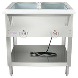 A stainless steel electric steam table with two sink-like wells, two control knobs, a lower storage shelf, and a black power cord resting on the bottom shelf. The 2-well steam table has four legs and a smooth, clean surface.