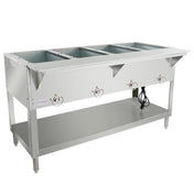 A four-compartment electric steam table with adjustable temperature knobs and an open lower shelf. Power cord is visible, and the table stands on four sturdy legs with adjustable feet. The stainless steel surface is clean and empty.