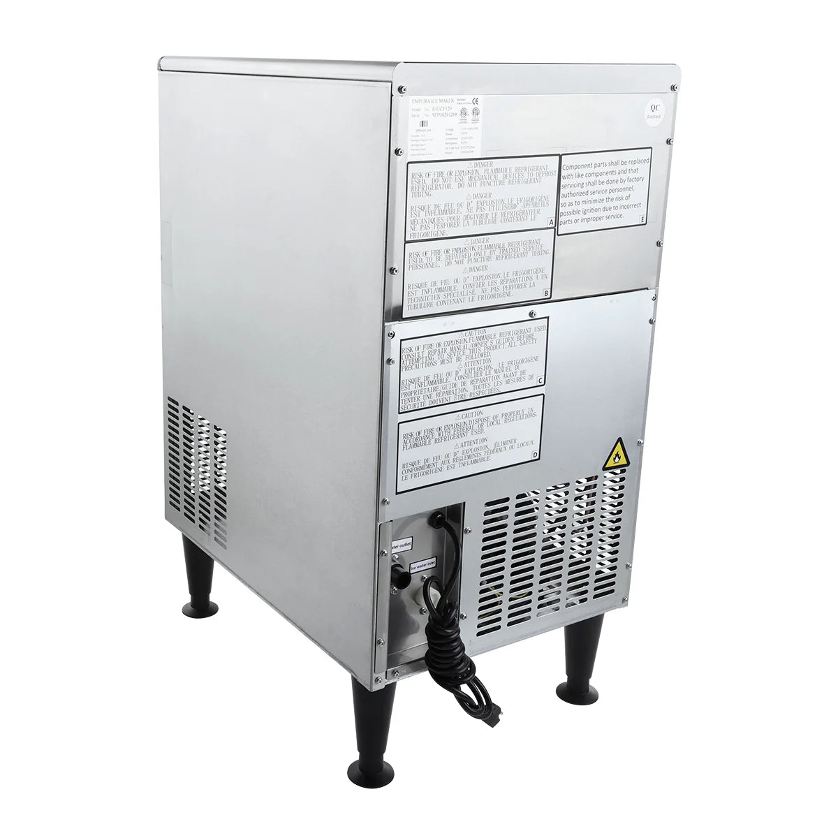 An Empura ice machine stands on four black legs. This commercial ice machine features vents on the sides and back, several warning labels, a power cord hanging from the rear, and a triangular caution sticker near the bottom vent.