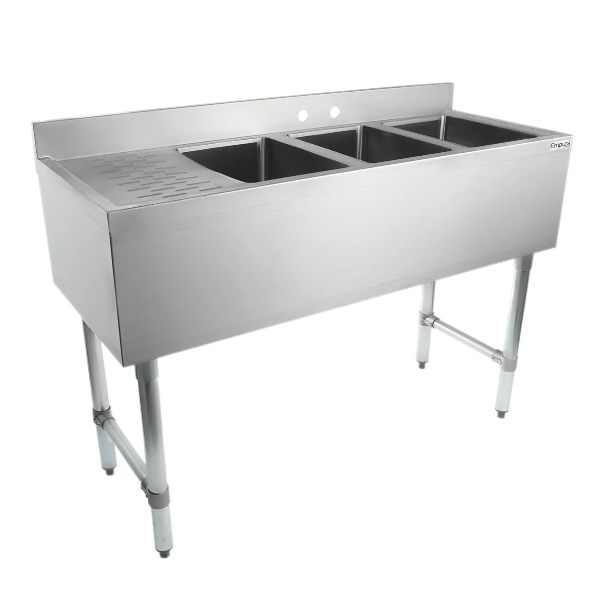 A commercial 3 compartment stainless steel underbar sink featuring three deep rectangular basins and a ribbed drainboard on the left, supported by four sturdy cylindrical legs. The high backsplash includes two faucet holes.