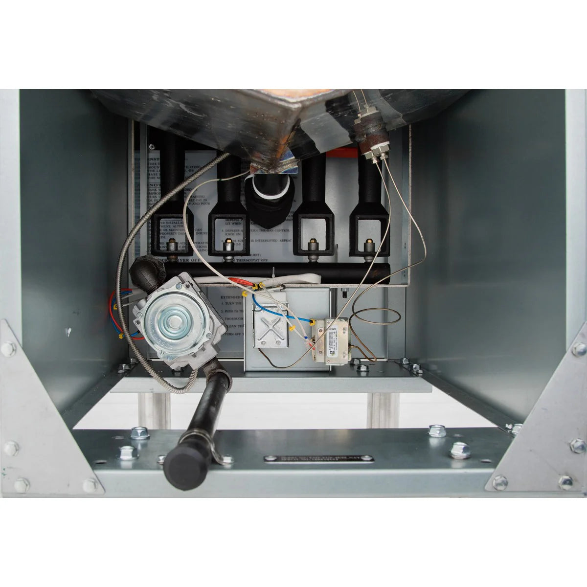 Close-up view of the interior of a commercial gas fryer, showing metal components, control wiring, a gas valve, burner tubes, and igniter. Electrical wires connect to controls as sturdy metal framing encloses the unit. Perspective is from the bottom front panel.