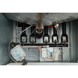 Interior view of a commercial fryer gas burner compartment, showing four black tubes, wiring, a silver gas valve, control board, and sensors. Labels with instructions are visible inside this 80lb oil capacity gas fryer unit.