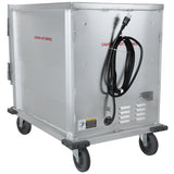 A large, metal, rectangular Heated Holding Cabinet with a 12 pan capacity sits on four gray caster wheels. It features a hinged side door, black power cord coiled on the front, and red text reading CAUTION - HOT SURFACE. Warning labels are visible.