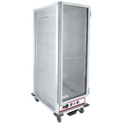 A tall, silver, full size heated holding cabinet with an open door, four caster wheels, and control knobs at the bottom front. The interior has rack supports for shelving, and a red label on the door reads CAUTION HOT SURFACE.