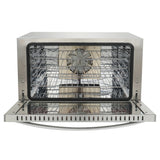 A countertop electric oven with a stainless steel exterior sits open, revealing multiple wire racks, a convection fan at the back, and a reflective interior. Its clean, modern boxy design highlights the unused state of this versatile appliance.