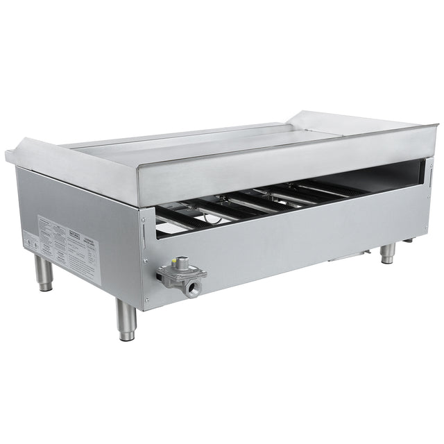 A large, rectangular commercial gas griddle with four sturdy legs, an open front panel revealing internal components, a control knob on the side, and a flat countertop griddle surface with raised edges and a rear splash guard.