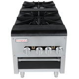 A commercial stainless steel natural gas range with four black cast iron burners, four silver control knobs, and an Empura brand label on the front. The stove stands on four short legs and features a black lower storage or oven section.