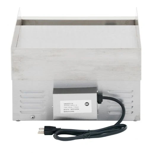 A stainless steel commercial electric countertop griddle with a boxy design is shown from the back. An electrical box with a label and a power cord featuring a standard two-pronged plug is attached. The upper part has a flat griddle surface.