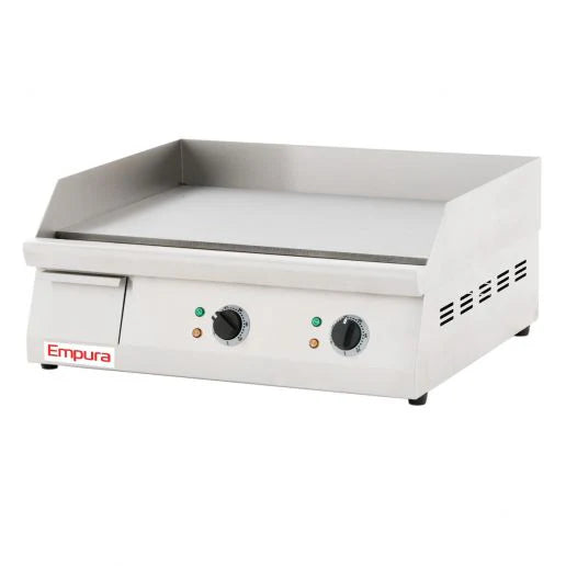 The Empura griddle is a stainless steel electric countertop griddle featuring side and back splash guards, two control knobs with indicator lights, vent holes on the sides, and a flat cooking surface. The Empura name appears on the front left corner.