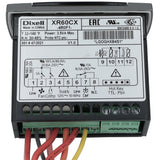 A close-up of a Dixell XR60CX electronic temperature controller for Empura Refrigeration. The front panel displays model info, technical specs, a wiring diagram, button symbols, and LEDs. Colored wires connect to green terminal blocks below.