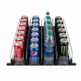 Three rows of beverages in a black organizer with clear dividers: a shelf accessory displaying red Coca-Cola cans, blue Pepsi cans and Dasani bottles, plus black-and-green Monster Energy. Perfect for Empura Refrigeration or product pusher systems.