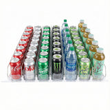 Rows of assorted drinks in a fridge organizer—cans of Coca-Cola, Sprite, Monster Energy, Dasani water bottles, and more—all neatly arranged on clear plastic tracks with a Product Pusher add-on accessory, ideal for Empura Refrigeration units.