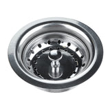 A shiny Empura stainless steel sink strainer with circular holes around its inner edge. Designed as a 3.5" basket drain, its center features a small knob for lifting. The polished metallic surface and round shape stand out against the white background.