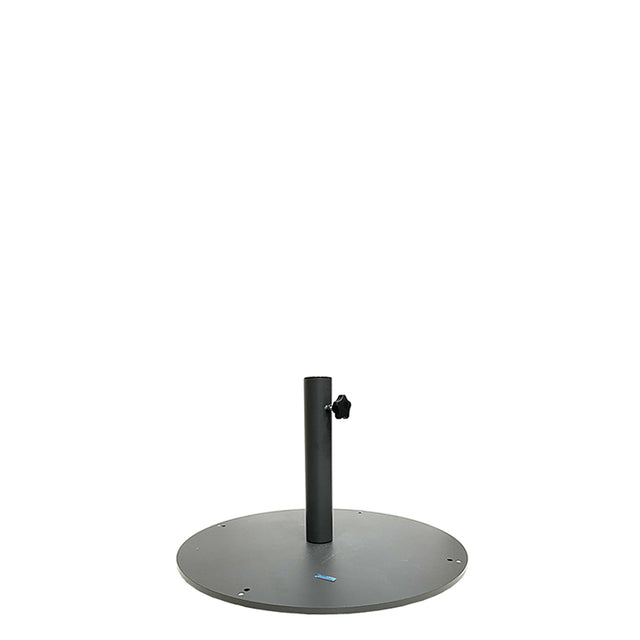 A round, flat, dark gray steel base with a vertical central pole and an adjustable knob on the side, designed to hold a patio or outdoor Shade Umbrella Base securely in place. The 24" dia. base has bolt holes around its edge for extra stability.