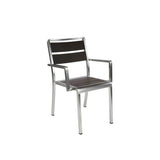 A modern stacking arm chair with a silver metal frame and straight legs, featuring dark brown wood-look aluminum slats on the seat and backrest. This minimalist indoor outdoor chair has armrests and a sleek, contemporary design, shown against a plain white background.