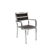 A modern stacking arm chair with a silver metal frame and straight legs, featuring dark brown wood-look aluminum slats on the seat and backrest. This minimalist indoor outdoor chair has armrests and a sleek, contemporary design, shown against a plain white background.