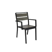 A modern indoor outdoor chair with a black metal frame, straight armrests, and two horizontal wooden slats in a light brown finish. This stacking arm chair features clean lines, a sturdy build, and a simple, geometric design.
