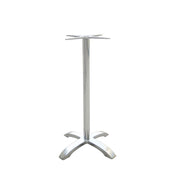 The Zak Table Base features a bar height, silver cast aluminum build with a tall cylindrical center pole, an X-shaped support for attaching a tabletop, and four curved legs for stability, shown on a white background.