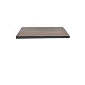 A rectangular wood-look aluminum outdoor table top with a dark frame and smooth, evenly spaced wooden slats appears to float against a plain white background. The surface design combines durability and sleek style for modern spaces.
