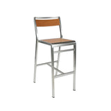 The Sid Barstool features a modern silver metal frame and light wood-look aluminum slats on the seat and backrest. Perfect for indoor/outdoor spaces, its clean, minimalistic design includes four straight legs and a square footrest for added stability.