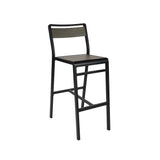 A modern Sid Barstool with a black metal frame, straight backrest, and wood-look aluminum rectangular seat. Designed for indoor/outdoor use, it features four legs with support bars, including a footrest, and is isolated on a white background.
