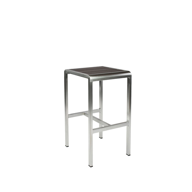 The Sid Barstool features a brushed metal frame and a rectangular, dark wood-look aluminum seat. Perfect for outdoor/indoor spaces, its minimalist and industrial design includes four straight legs and a sturdy horizontal support bar.
