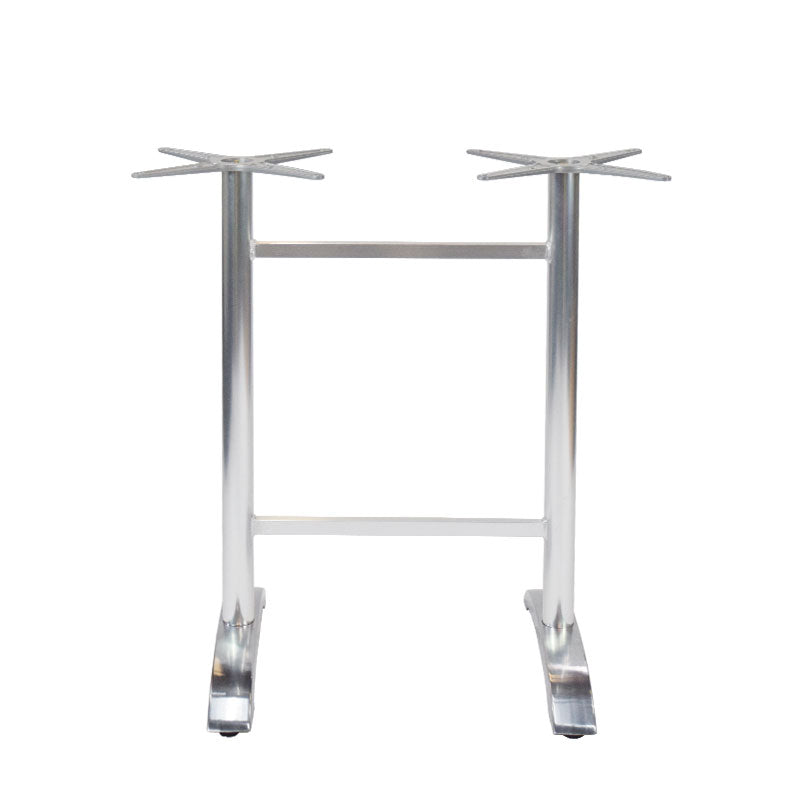 The Zak Table Base is a cast aluminum metal base with a silver finish, featuring two vertical legs connected by a horizontal bar. Each leg has a star-shaped mount on top and flat, angled feet for floor stability—ideal for bar height tables.