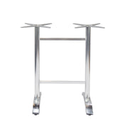 The Zak Table Base is a cast aluminum metal base with a silver finish, featuring two vertical legs connected by a horizontal bar. Each leg has a star-shaped mount on top and flat, angled feet for floor stability—ideal for bar height tables.