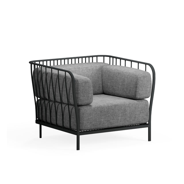A modern Cannolè Lounge Armchair with a black steel wire back and metal frame featuring vertical, curved lines, plus thick gray cushions. Its airy, open structure and four straight legs make it ideal as an outdoor armchair against a white background.