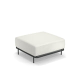 The Cannolè Lounge Ottoman features a minimalist, modern design with a thick white cushion atop a slim, black steel frame and four black legs. Suitable for outdoor/indoor use, it sits elegantly against a plain white background.