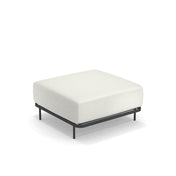 The Cannolè Lounge Ottoman features a minimalist, modern design with a thick white cushion atop a slim, black steel frame and four black legs. Suitable for outdoor/indoor use, it sits elegantly against a plain white background.