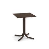 A small, square, brown solid surface table with a flat top and a single central pedestal. The pedestal branches into four curved legs at the base, each ending with a slightly upturned foot. The table is set against a white background.