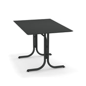 A rectangular black solid surface table with a thin, flat top and two curved metal pedestal legs joined at the center. Wide, flat feet provide stability. Suitable as an indoor/outdoor table, it is shown against a plain white background.