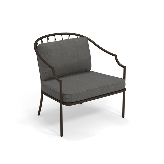 The Como Lounge Arm Chair features a modern design with a dark steel wire frame. Suitable for indoor/outdoor spaces, it has a curved backrest with vertical bar details and plush, textured gray cushions for added comfort.